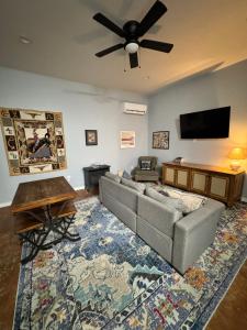 a living room with a couch and a flat screen tv at Yellowstone Hideaway in Livingston