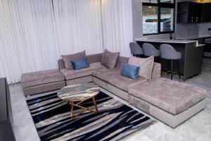 a living room with a couch and a table at Beza Residence in Ruhengeri