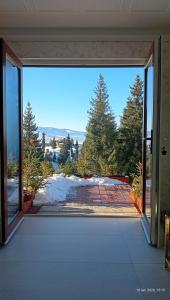 an open door to a patio with a view at Harmony Retreat in Dealu Negru