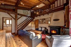 a living room with a couch and a fireplace at Chalet Les Frenes in Chamonix +16 photos
