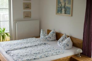 a bed with blue and white pillows on it at Ferienhaus Kaptein Meyer in Zingst
