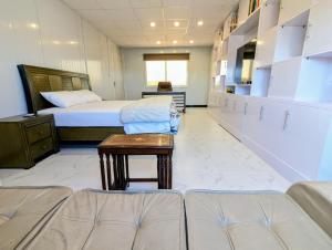 a hospital room with two beds and a couch at Dhan Valley Guest House in Bhaun