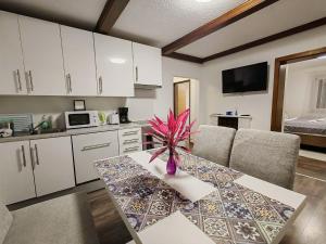 a kitchen with a table with a vase on it at Eisenerzer Apartmenthaus in Eisenerz