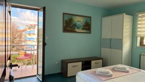 a bedroom with a bed and a sliding glass door at Apart Ludmila in Bečići