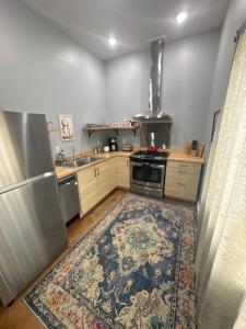 a kitchen with a stove and a rug on the floor at Yellowstone Hideaway in Livingston
