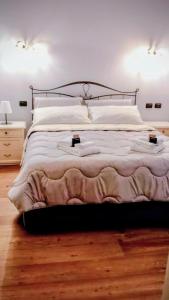 a bedroom with a large bed with white pillows at Bernina House in Chiesa in Valmalenco