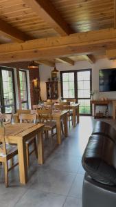 a dining room with wooden tables and chairs at Wypoczynek pod Lipami in Ruciane-Nida