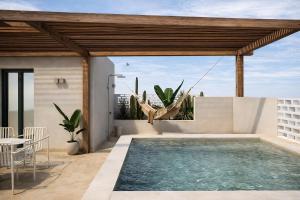 a swimming pool on the roof of a house at Astypalaia Hotel Palace in Astypalaia