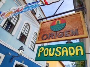 a sign for a restaurant in front of a building at Origem Bahía in Salvador