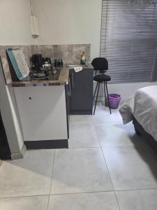 a kitchen with a counter and a counter top at The Good Samaritan 1 in eMalahleni +6 photos