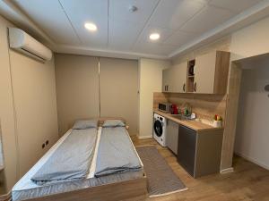 a small room with a bed and a kitchen at Nõma studio in Varna City