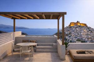 a balcony with a table and a view of a city at Astypalaia Hotel Palace in Astypalaia +38 photos