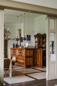 a living room with a wooden counter and a table at Folwark Wielka Wieś in Główczyce