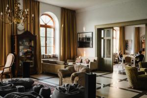 a living room with couches and chairs and a table at Folwark Wielka Wieś in Główczyce