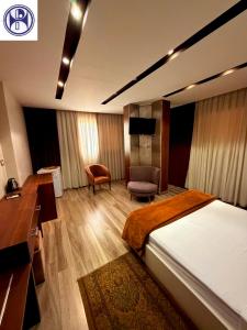 a hotel room with a bed and a desk and chair at Panorama Portsaid Hotel in Port Said