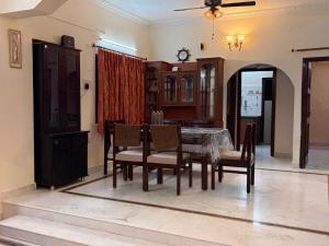a dining room with a table and chairs at Naidu Villa in Secunderabad