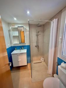 a bathroom with a shower and a sink and a toilet at Delfines 61 in Corralejo