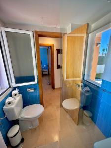 a bathroom with a toilet and a glass shower at Delfines 61 in Corralejo
