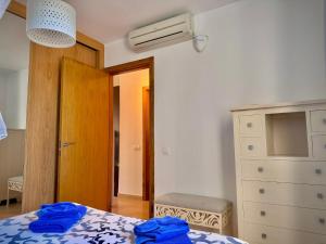 a bedroom with a bed and a dresser and a fan at Delfines 61 in Corralejo