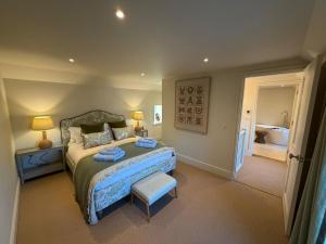 a bedroom with a bed and a bathroom with a tub at Gilchrist Square in Dornoch +13 photos