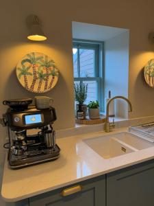 a kitchen with a coffee maker on a counter at Gilchrist Square in Dornoch