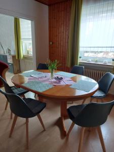 a wooden table in a room with chairs around it at Ferienhaus Hanna in Apen