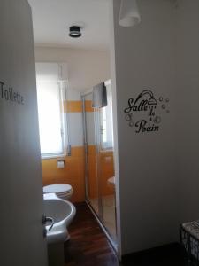 a bathroom with three toilets and a sign on the wall at Primo Piano in Enna