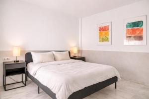 a bedroom with a large bed with two night stands at Sofia Luxury Apartment in Seville