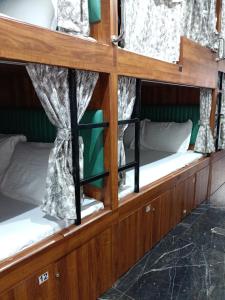 a row of bunk beds on a boat at Sunlight Dormitory in Mumbai
