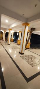 a lobby with yellow columns and a floor at Minx guest house in Candolim