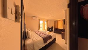 a bedroom with a bed and a living room at Kings Rest Bed And Breakfast in Gaborone +12 photos