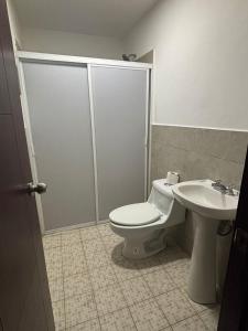 a bathroom with a toilet and a sink at Depa Balbuena in Guadalajara +4 photos
