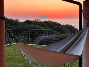 a hammock with a view of a mountain at GREEN APARTMENT in VILLA ANGISI in Drapia +20 photos