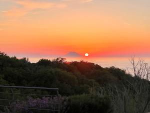 a sunset with a mountain in the background at GREEN APARTMENT in VILLA ANGISI in Drapia