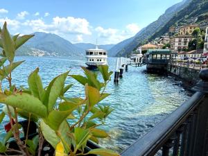 a boat is docked at a dock in the water at Como Lake View in Brienno