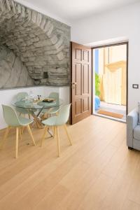 a dining room with a glass table and chairs at Como Lake View in Brienno