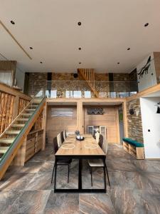 a dining room with a table and a staircase at Loft Chalet Bansko in Bansko
