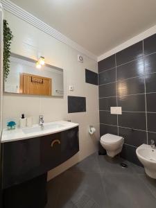 a bathroom with a sink and a toilet at Vela Terrace in Monte Gordo
