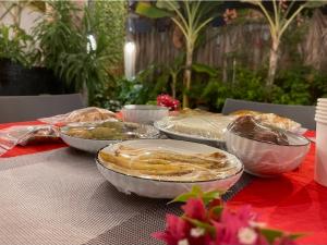 a table topped with bowls of food on a table at Thilavaru Inn in Dhangethi +25 photos