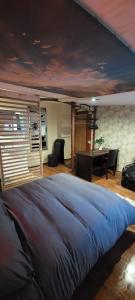 a bedroom with a large bed and a table at Ofiss 24 in Riga