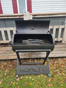 a bbq grill with a gun on it at Chalet First Stage - Renesse in Renesse