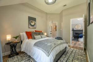 a bedroom with a large bed with orange pillows at Stylish Oasis Modern Living in Allen +63 photos