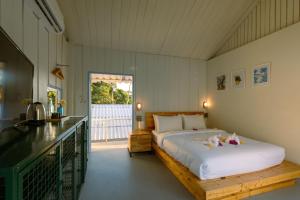 a bedroom with a large bed and a balcony at Slumber Resort Koh Chang in Ko Chang +74 photos