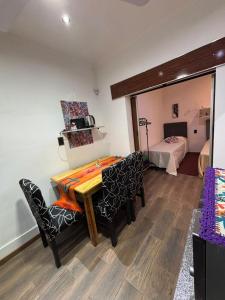 a room with a table and chairs and a bed at Sarr in Santa Fe