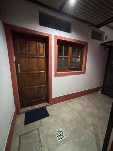 a room with two wooden doors and a tile floor at Sarr in Santa Fe