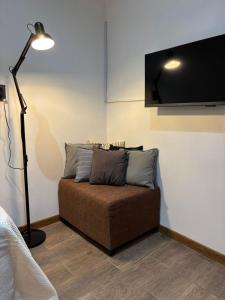 a couch in a room with a lamp and a tv at Sarr in Santa Fe