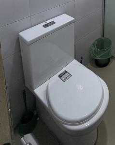 a bathroom with a white toilet in a stall at Modern 2BR in Lekki Phase 1 in Lekki