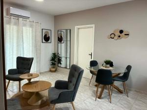 a living room with a table and chairs at Karadinos Apartment in Stílos