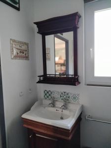 a bathroom with a sink and a mirror at Murmure de Tilleul in Alembon +42 photos