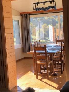 a dining room with a table and chairs and a window at Chalet Belfahy in Belfahy +18 photos